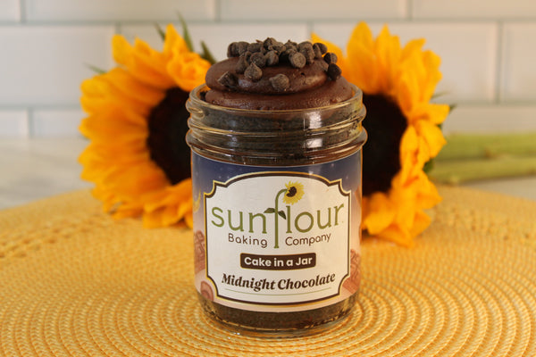 Sunflour Baking Company’s Midnight Chocolate Cake Jar, topped with chocolate chips, is a delicious dessert gift.