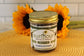 A jar labeled Sunflour Baking Company VGF Cookies and Cream is displayed in front of two sunflowers.