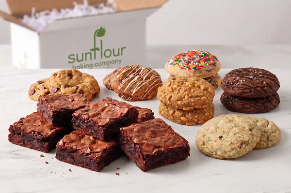 The Sunflour Baking Company Corporate Gift Box features assorted brownies and cookies displayed on a white surface.