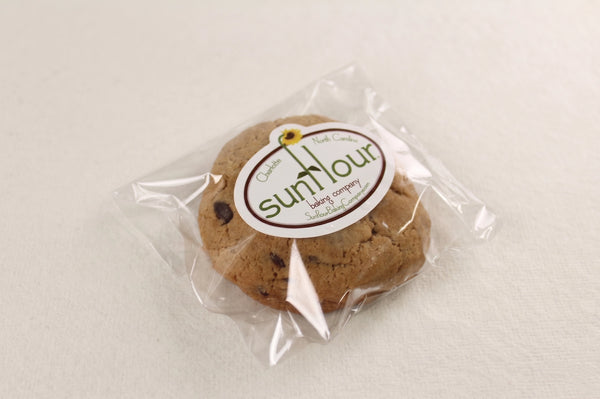 A Double Chocolate Chip Cookie from Sunflour Baking Company is sealed in clear plastic—perfect for chocolate lovers.