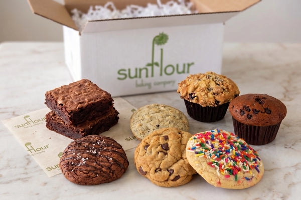 The Dessert Gift Box by Sunflour Baking Company features cookies, brownies, and muffins in a charming box.