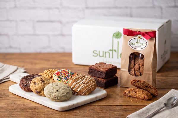 Assorted cookies, brownies, and biscotti from Sunflour Baking Company’s Thank You Gift Basket displayed on a marble tray.